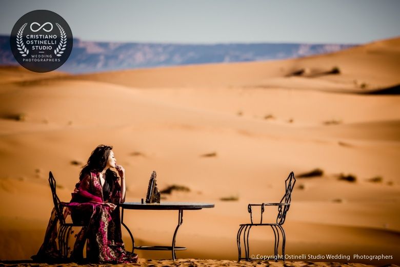 Image of a lady sitting amidst the desert